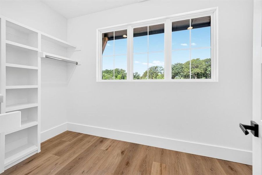 Master closet with expansive windows to allow in natural light. Master closet with expansive windows to allow in natural light.