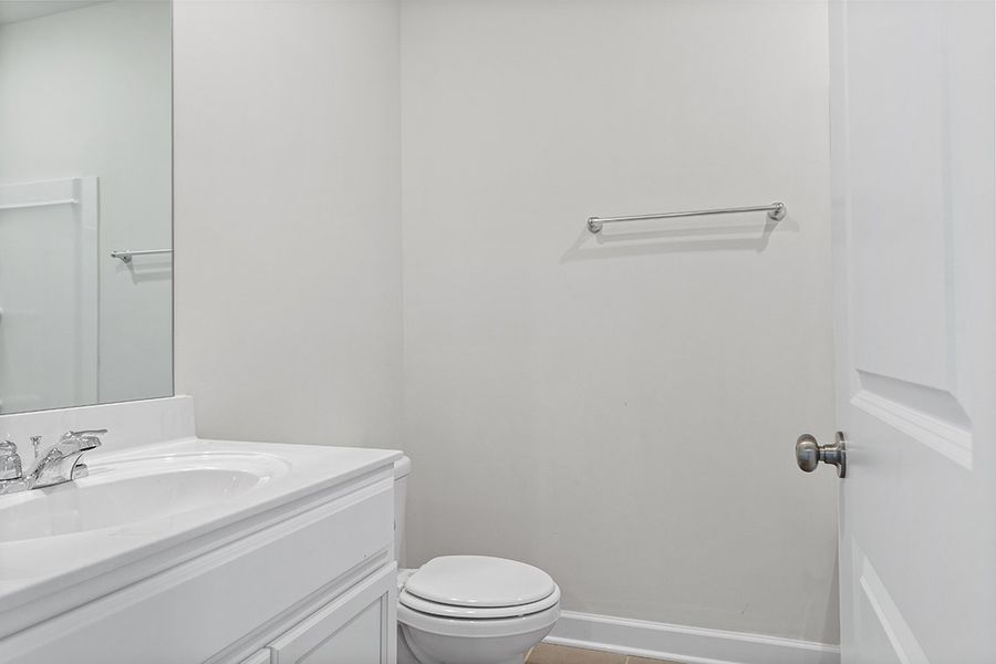 A bathroom with a toilet sink and mirror. A bathroom with a toilet sink and mirror.