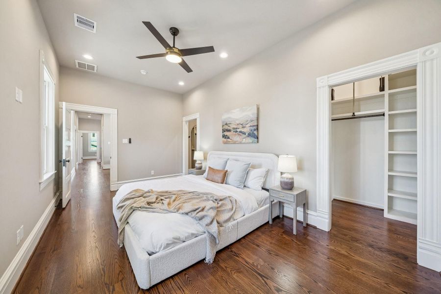 Another view of the primary bedroom! With a peek into the walk-in closet with custom built storage Another view of the primary bedroom! With a peek into the walk-in closet with custom built storage