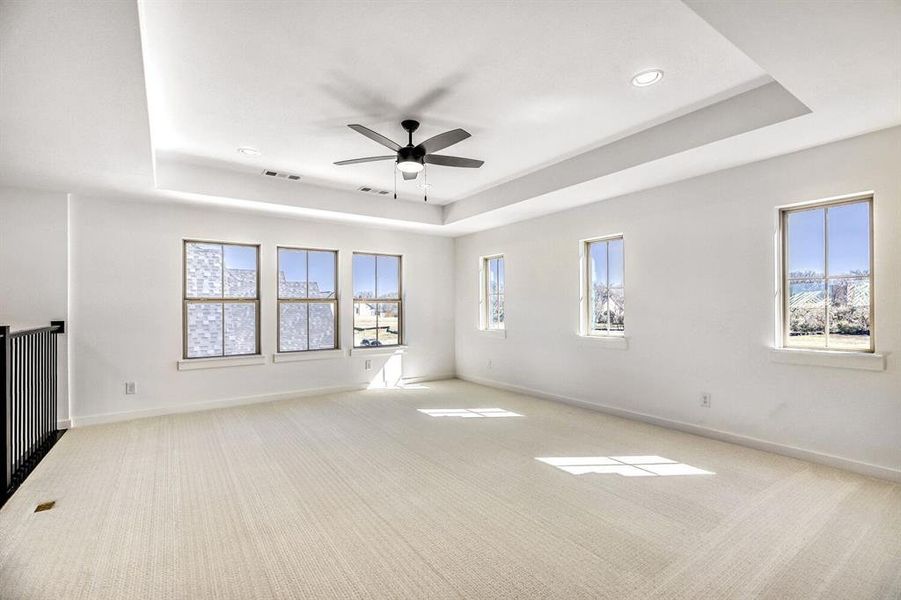 Unfurnished room featuring ceiling fan, a tray ceiling, carpet, and recessed lighting
