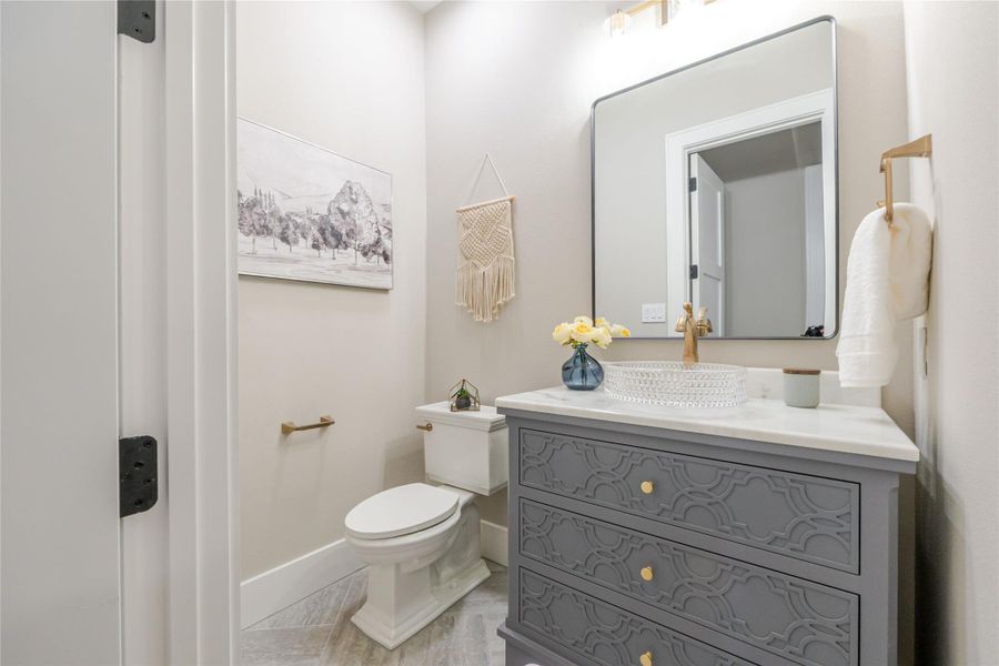 Half bathroom with toilet and vanity