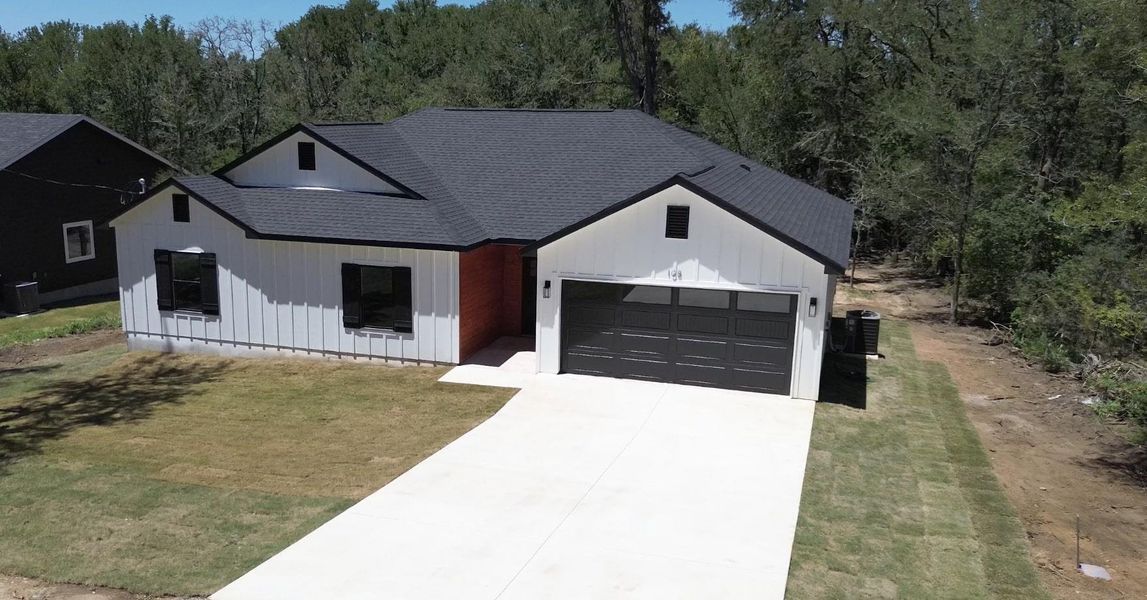 Front exterior of a new home in , Bastrop, TX, highlighting curb appeal (Image 21). Front exterior of a new home in , Bastrop, TX, highlighting curb appeal (Image 21).