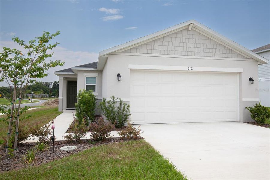 Front exterior of a new home in , Leesburg, FL, highlighting curb appeal (Image 1). Front exterior of a new home in , Leesburg, FL, highlighting curb appeal (Image 1).