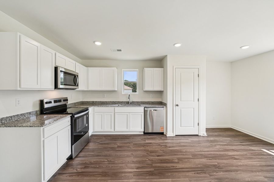 A kitchen with white cabinets. A kitchen with white cabinets.