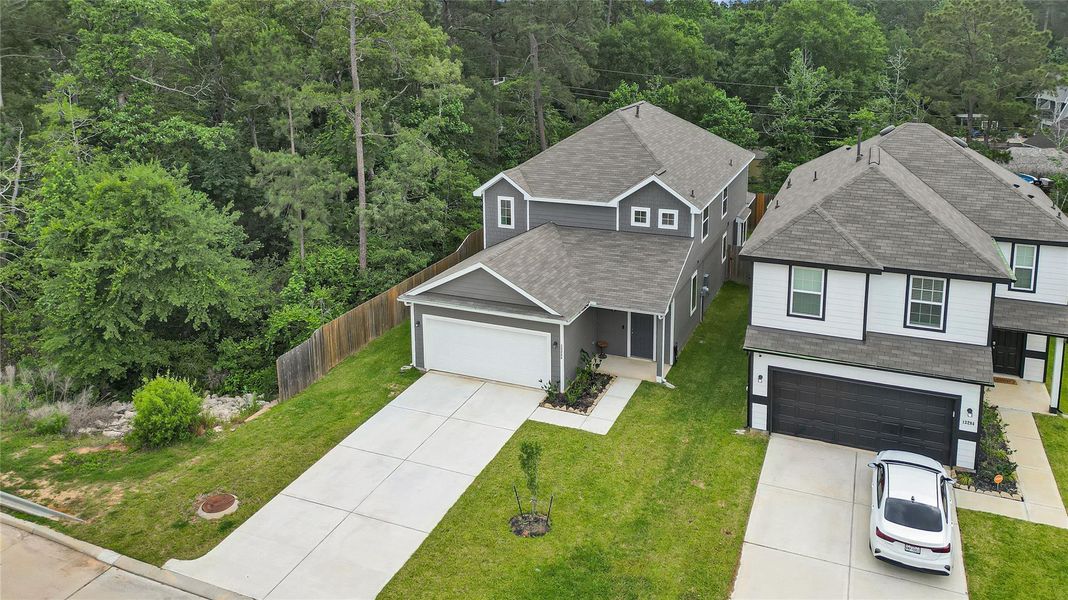 Front exterior of a new home in River's Edge, Conroe, TX, highlighting curb appeal (Image 22).