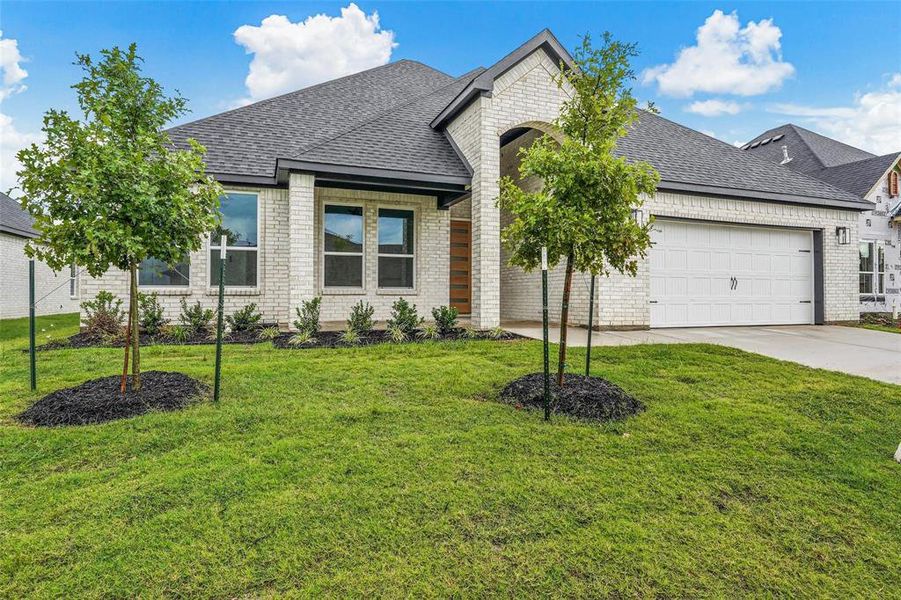 View of front of house with a shingled roof, an attached garage, brick siding, and concrete driveway View of front of house with a shingled roof, an attached garage, brick siding, and concrete driveway