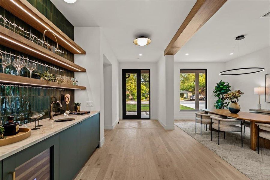 Custom wet bar with Thermador wine fridge, floating shelves with LED lighting.