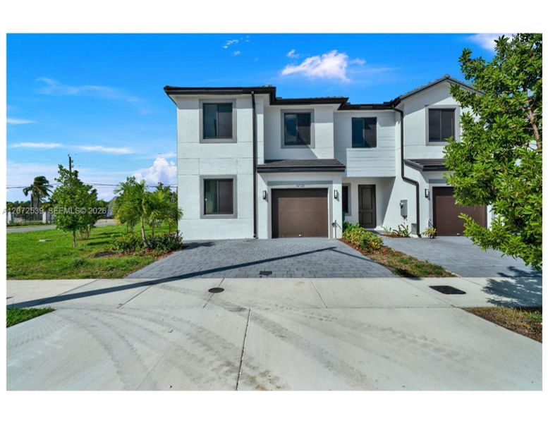 Front exterior of a new home in , Homestead, FL, highlighting curb appeal (Image 19).