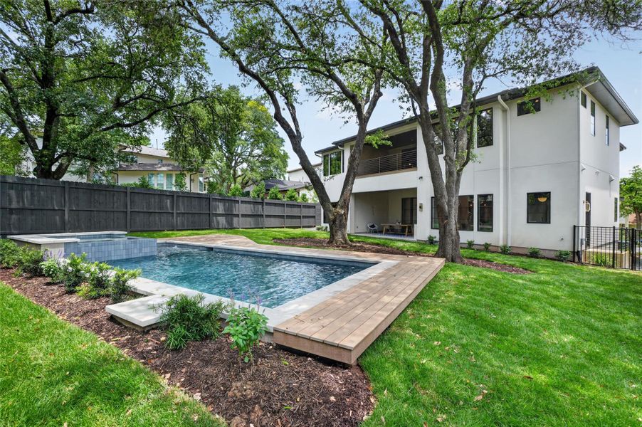 An inviting pool with a relaxing spa offers the perfect backyard oasis.