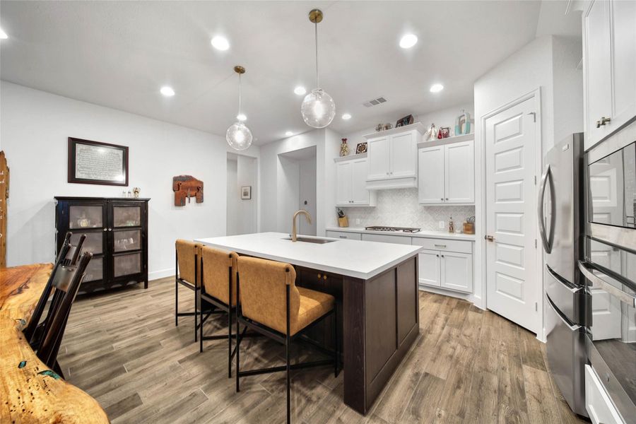 The walk-in pantry offers custom pull-out storage, making it easy to stay organized.