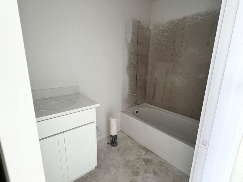 Bathroom with vanity and tub / shower combination