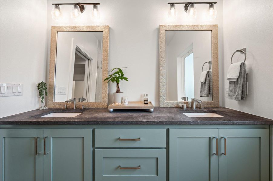 Primary Bathroom with natural stone stink, floating custom cabinets with slow close doors and drawers and one large drawer with electrical plug inside the drawer for hidden use.