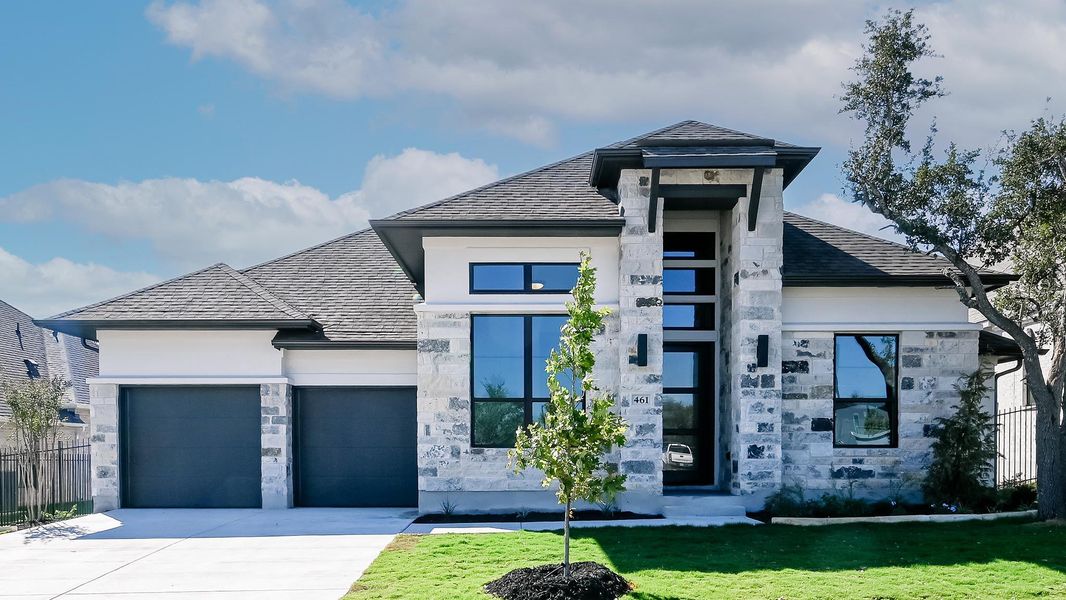 View of front facade featuring stone siding, roof with shingles, a garage, concrete driveway, and stucco siding View of front facade featuring stone siding, roof with shingles, a garage, concrete driveway, and stucco siding