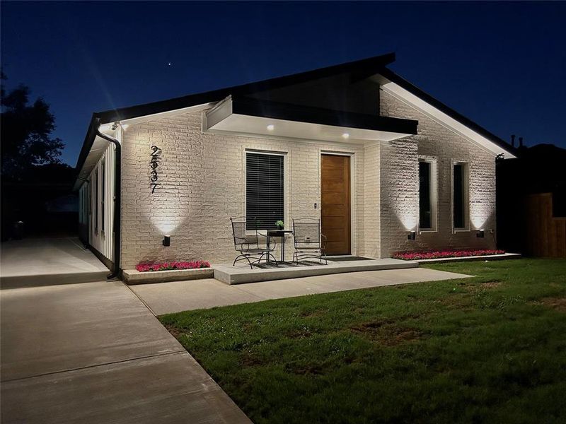 Front View of Home Featuring Accent Lighting