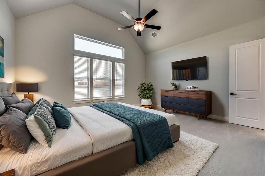 Bedroom featuring high vaulted ceiling, light colored carpet, a ceiling fan, visible vents, and baseboards