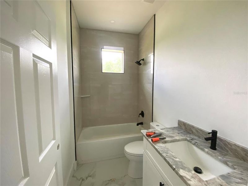 hall bath, granite vanity top, tiled tub/shower combo