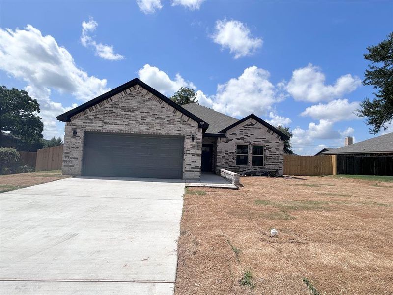 View of front of home featuring an attached garage, brick siding, and driveway View of front of home featuring an attached garage, brick siding, and driveway