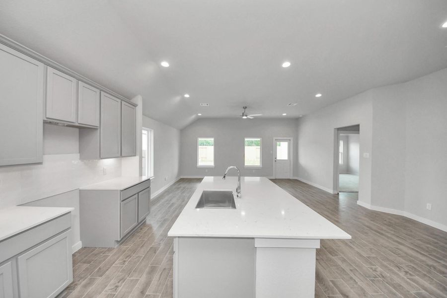 This kitchen is by far any chef’s dream! This spacious kitchen features high ceilings, light stained wood cabinets, granite countertop, SS appliances, modern tile backsplash, recessed lighting, extended counter space, granite kitchen island with double sink, and space for breakfast bar, and a walk-in pantry all overlooking your huge family room. Sample photo of completed home with similar floor plan. Actual colors and selections may vary. This kitchen is by far any chef’s dream! This spacious kitchen features high ceilings, light stained wood cabinets, granite countertop, SS appliances, modern tile backsplash, recessed lighting, extended counter space, granite kitchen island with double sink, and space for breakfast bar, and a walk-in pantry all overlooking your huge family room. Sample photo of completed home with similar floor plan. Actual colors and selections may vary.