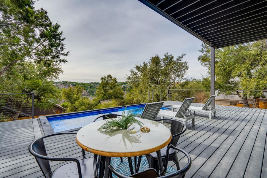 Back of property with a balcony and a yard