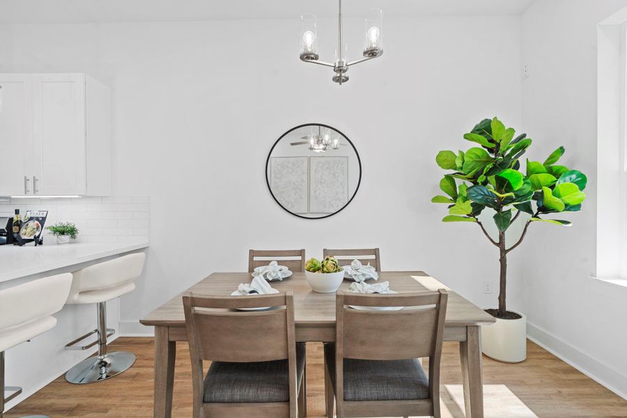 An open-concept dining area with stylish lighting