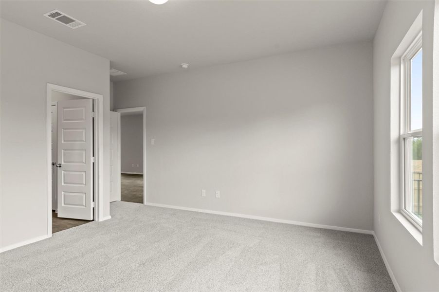 Empty room featuring dark carpet and baseboards