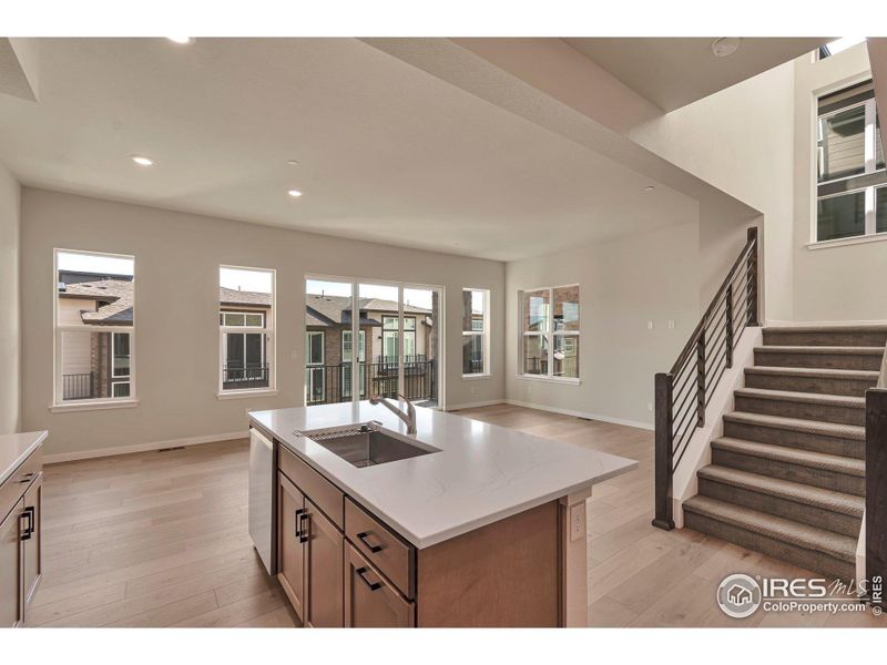 Kitchen Open to Dining and Family Room w/ Covered Deck