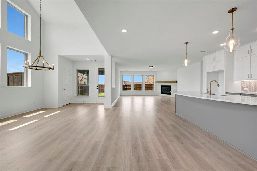 Expansive open-concept living space featuring wood-finish flooring throughout