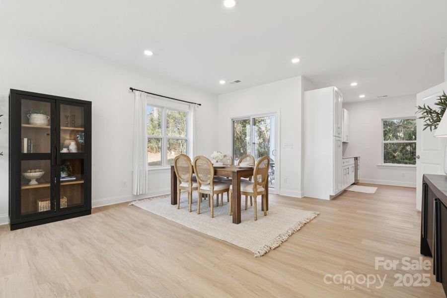 Living room flows seamlessly to the dining area, conveniently off the kitchen