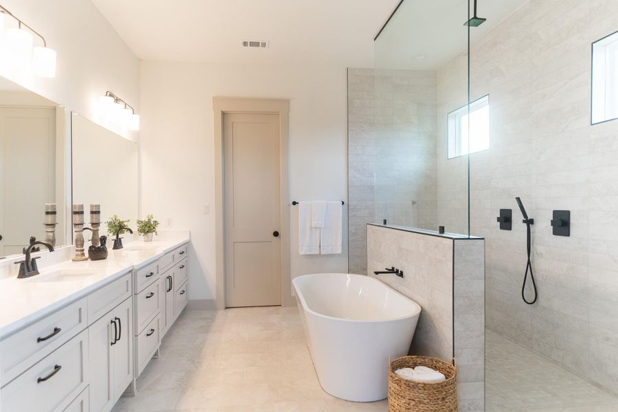 Bathroom with double vanity, a walk in shower, and a soaking tub Bathroom with double vanity, a walk in shower, and a soaking tub