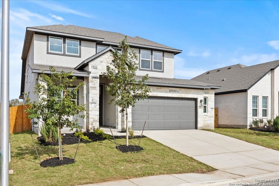 Front exterior of a new home in Stream Waters, Seguin, TX, highlighting curb appeal (Image 2). Front exterior of a new home in Stream Waters, Seguin, TX, highlighting curb appeal (Image 2).