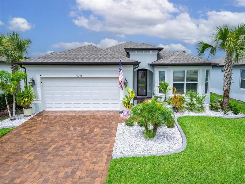 Front exterior of a new home in , Land O' Lakes, FL, highlighting curb appeal (Image 1).