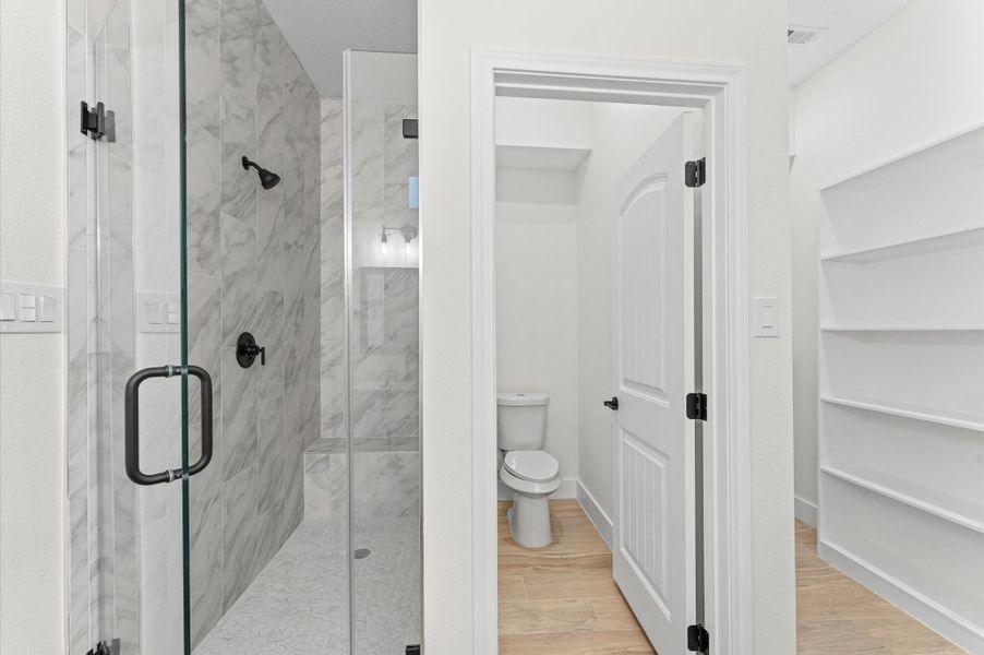 Spa-like primary bath featuring dual sinks, a luxurious walk-in shower with designer tile, and modern finishes that create a serene retreat for relaxation. Spa-like primary bath featuring dual sinks, a luxurious walk-in shower with designer tile, and modern finishes that create a serene retreat for relaxation.