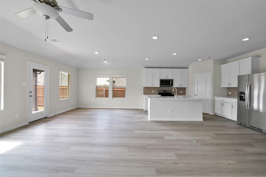 Unfurnished living room with light wood finished floors, recessed lighting, and ceiling fan Unfurnished living room with light wood finished floors, recessed lighting, and ceiling fan