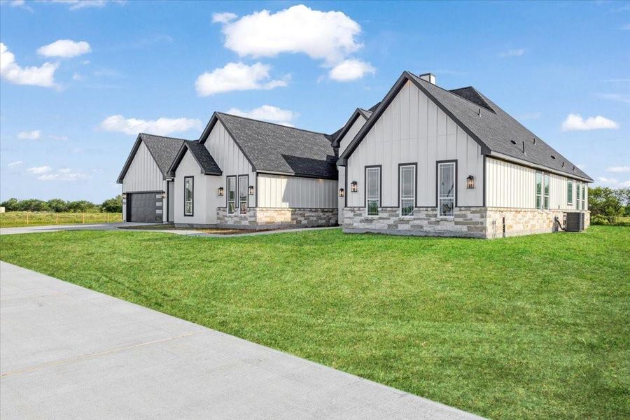 Front exterior showcasing the home's attractive modern farmhouse architecture and manicured lawn. Front exterior showcasing the home's attractive modern farmhouse architecture and manicured lawn.