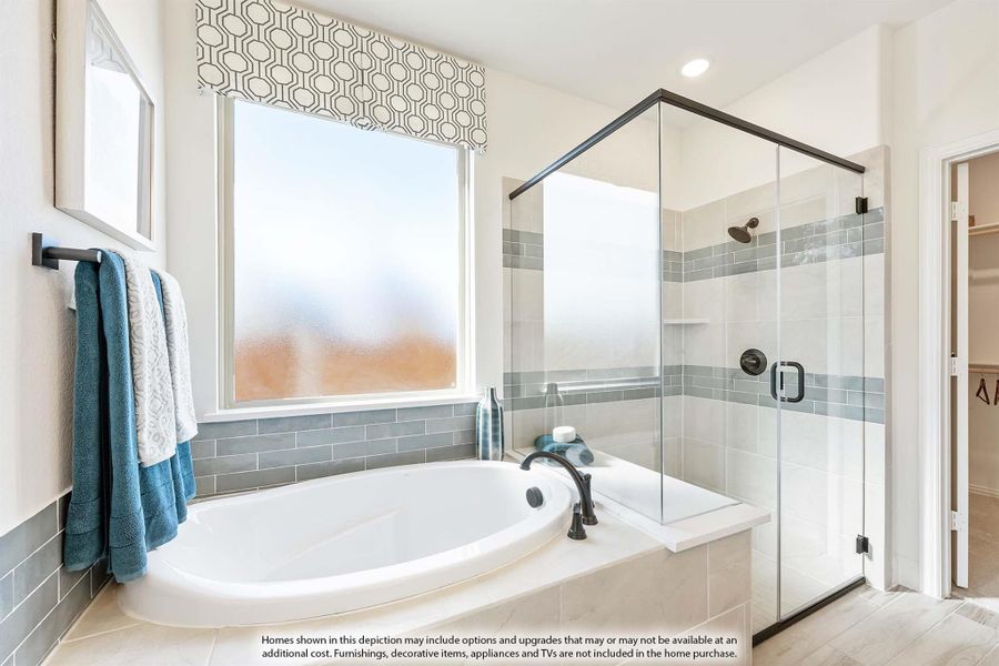 Master bathroom with soaking tub, glass-enclosed shower, gray tile accents, and a window above the tub. Master bathroom with soaking tub, glass-enclosed shower, gray tile accents, and a window above the tub.