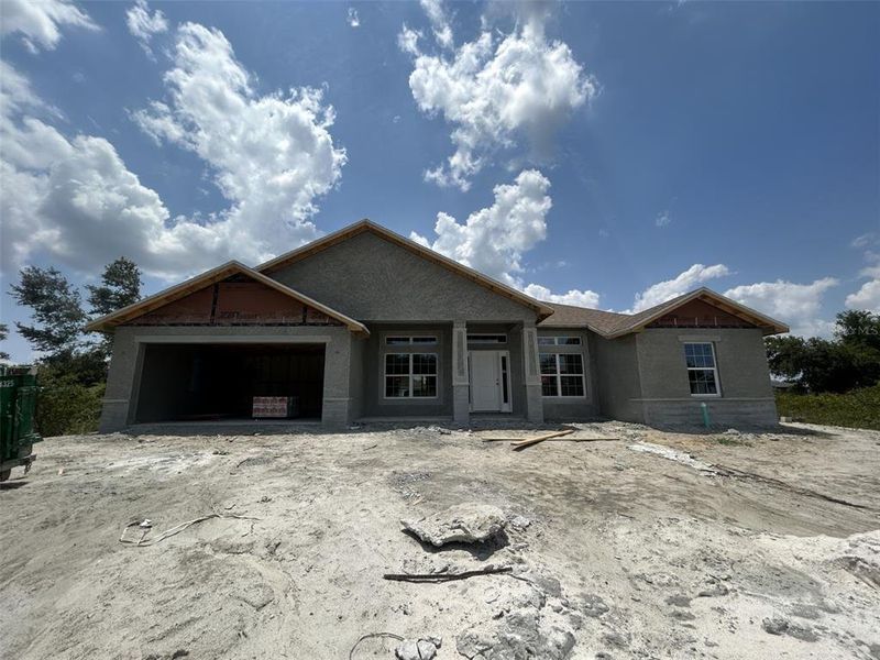 Front exterior of a new home in Deep Creek, Punta Gorda, FL, highlighting curb appeal (Image 13).