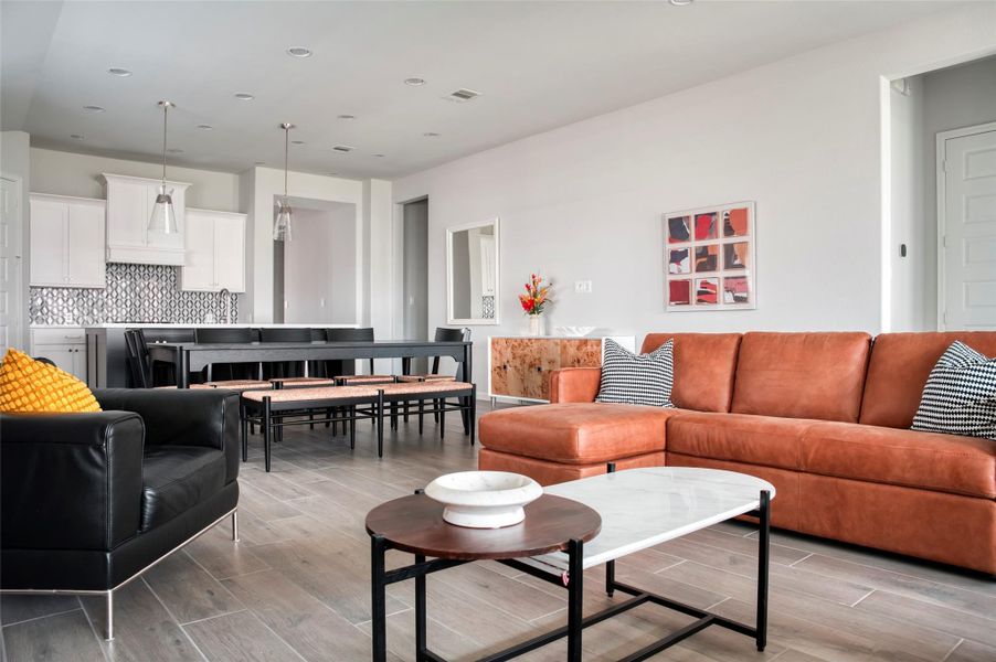 This modern living space features an open layout with a stylish kitchen, spacious dining area, and cozy seating. The room is bright and inviting, with contemporary furnishings and neutral tones that complement the sleek design. This modern living space features an open layout with a stylish kitchen, spacious dining area, and cozy seating. The room is bright and inviting, with contemporary furnishings and neutral tones that complement the sleek design.