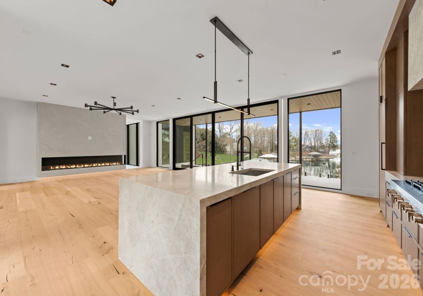 Kitchen featuring a waterfall island, custom cabinetry, and high-end appliances. Kitchen featuring a waterfall island, custom cabinetry, and high-end appliances.