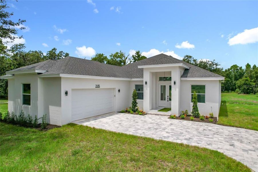 Front exterior of a new home in , Plant City, FL, highlighting curb appeal (Image 2). Front exterior of a new home in , Plant City, FL, highlighting curb appeal (Image 2).