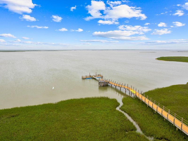 Enjoy instant access to the calm, protected waters of Drum Bay. The private boardwalk leads to a thoughtfully designed pier where you can fish, crab, or just watch the tide roll in. This is the kind of amenity that transforms a home into a legacy property.