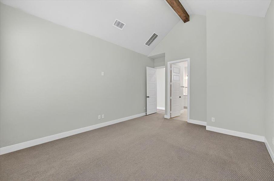 Vaulted ceiling with an exposed wood beam, light gray walls, and plush carpeting Vaulted ceiling with an exposed wood beam, light gray walls, and plush carpeting