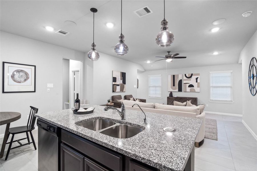 Preside over the main living space from this functional kitchen island, which provides an ideal vantage point into the living room, perfect for modern living and casual gatherings