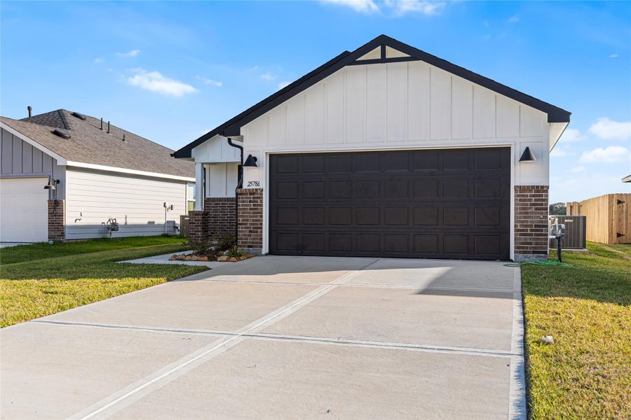Front exterior of a new home in Hill & Dale Ranch, Splendora, TX, highlighting curb appeal (Image 17). Front exterior of a new home in Hill & Dale Ranch, Splendora, TX, highlighting curb appeal (Image 17).