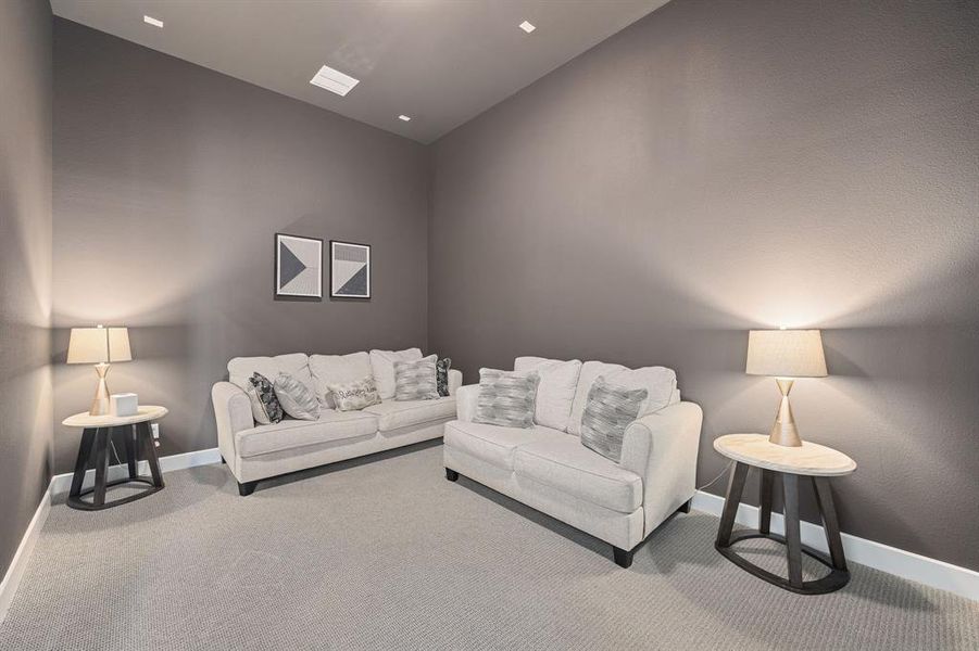 Living room featuring vaulted ceiling and carpet flooring