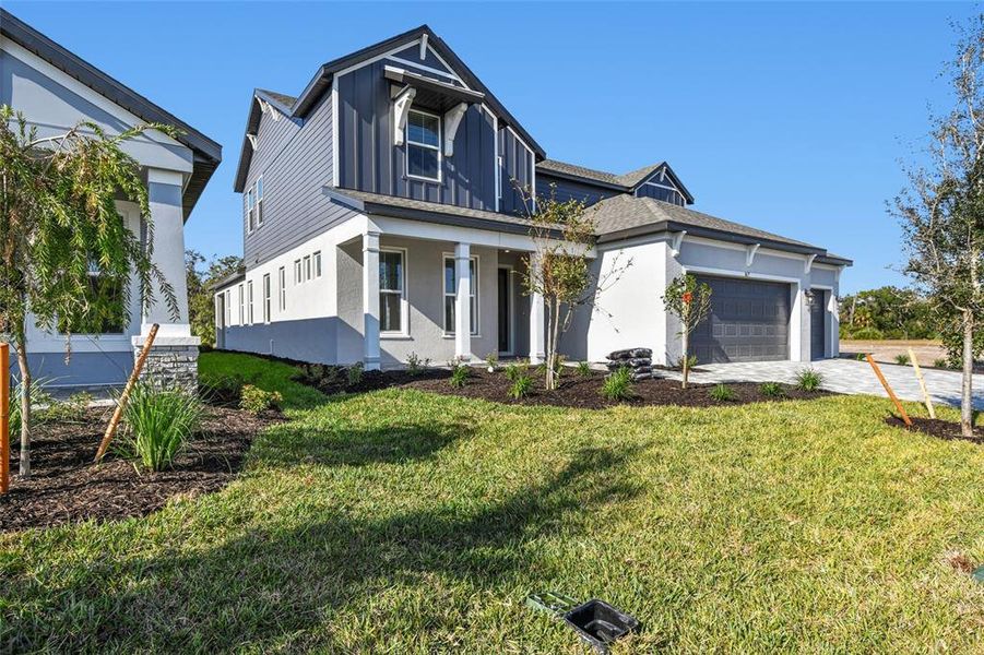Front exterior of a new home in Creeks Edge at Twin Rivers, Parrish, FL, highlighting curb appeal (Image 28).