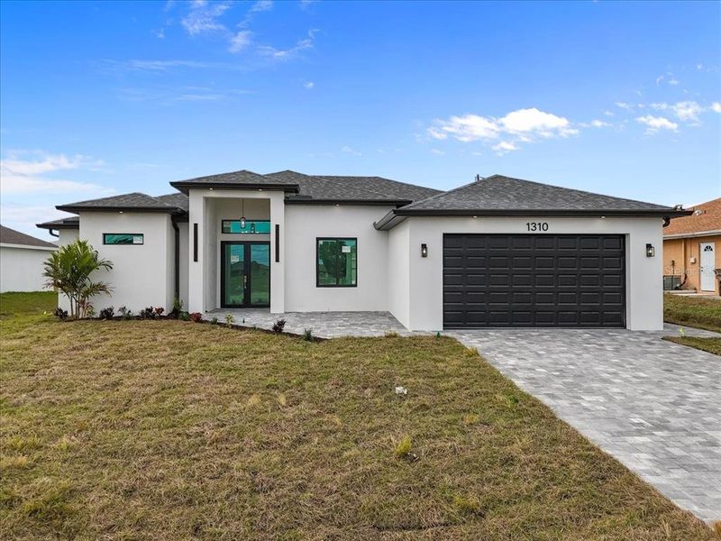Front exterior of a new home in , Cape Coral, FL, highlighting curb appeal (Image 26).