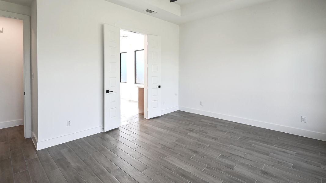 Unfurnished bedroom with baseboards and dark wood finished floors Unfurnished bedroom with baseboards and dark wood finished floors