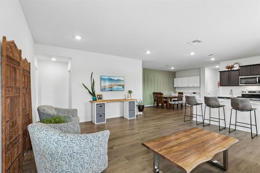 Living room featuring light wood-style floors and recessed lighting Living room featuring light wood-style floors and recessed lighting
