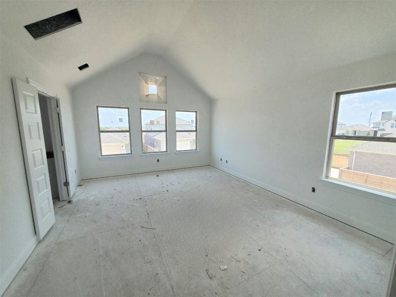 Unfurnished bedroom with lofted ceiling