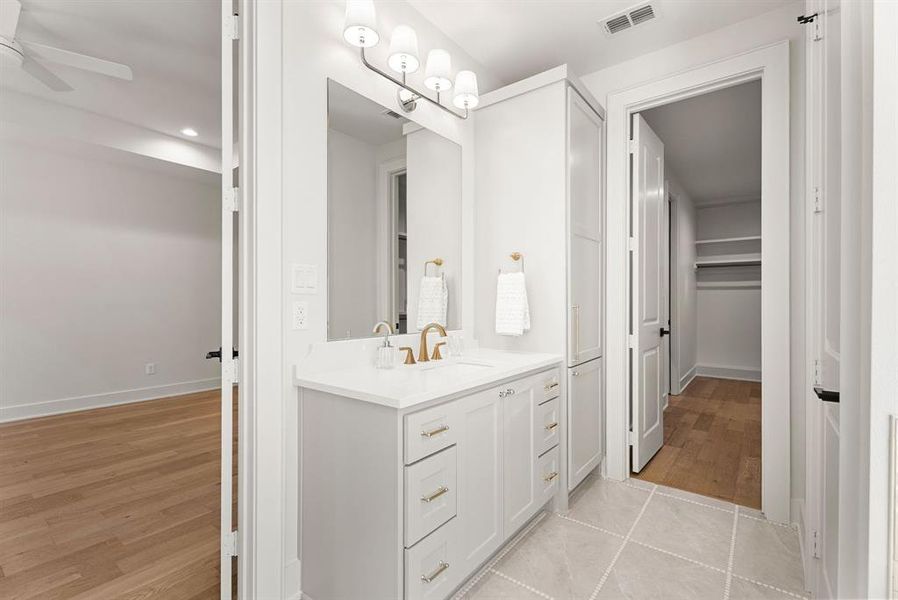 Bathroom featuring vanity, light wood-type flooring, recessed lighting, and a spacious closet